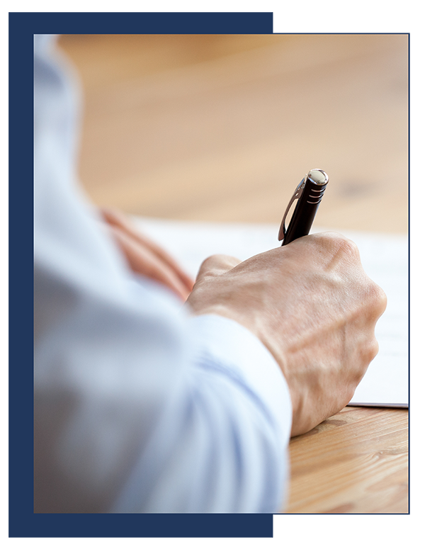 Image for letter of direction - a man's hand holding pen